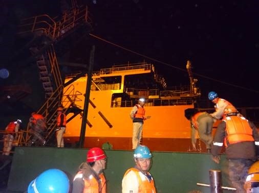 - Shipyard staff transferring from TUG boat to barge for final checking and launching survey.