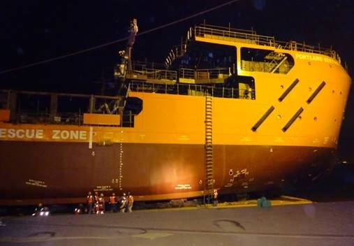-00:00 Final checking completed. Workers going on-board of Portland Sentinel for launching survey. Barge ready to be ballasted for submerging: